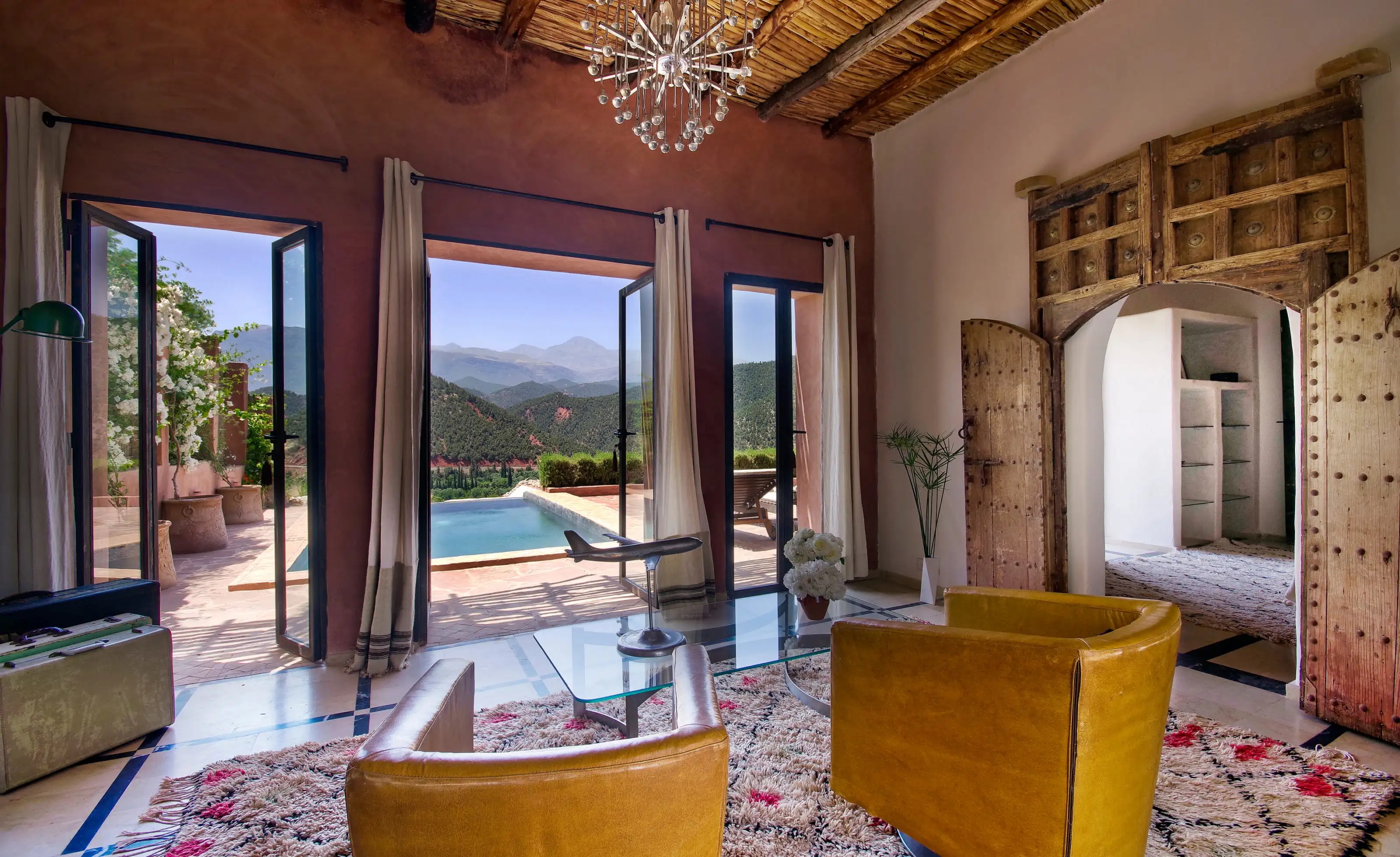 Suite sitting room opening towards a private pool at Kasbah Bab Ourika, Ourika Valley, Morocco