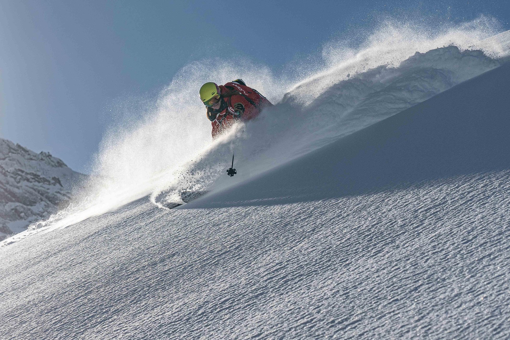 Skier carving through deep powder, Tordrillo Mountain Lodge, Alaska, USA