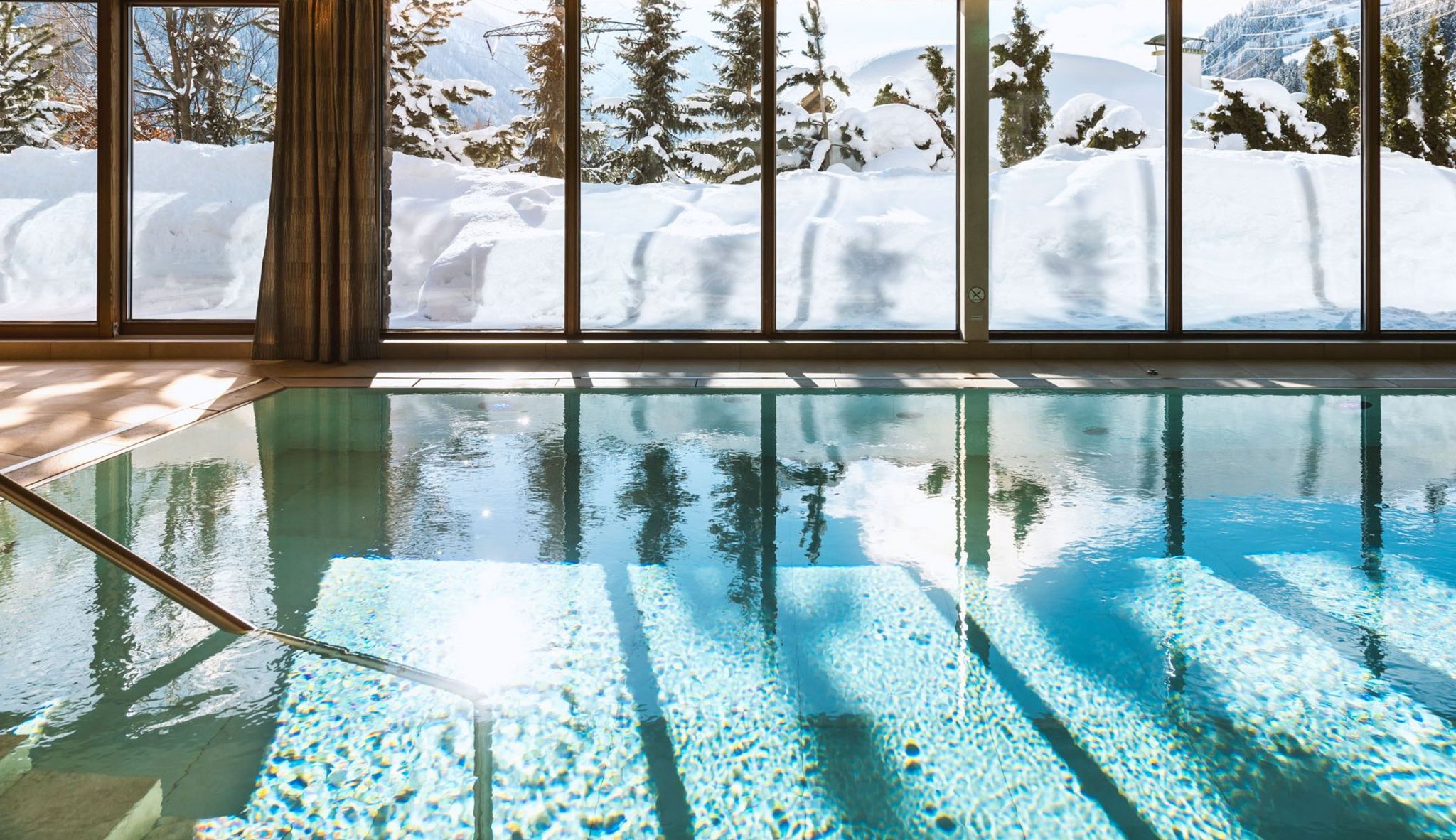 Pool water reflecting the snowy garden, Hotel Tannenhof, St. Anton am Arlberg, Austria