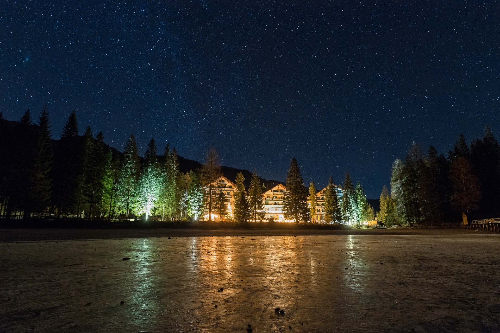 Hotel illuminated at night across the lake at Hotel Lago di Braies, Lago di Braies (Pragser Wildsee), Italy