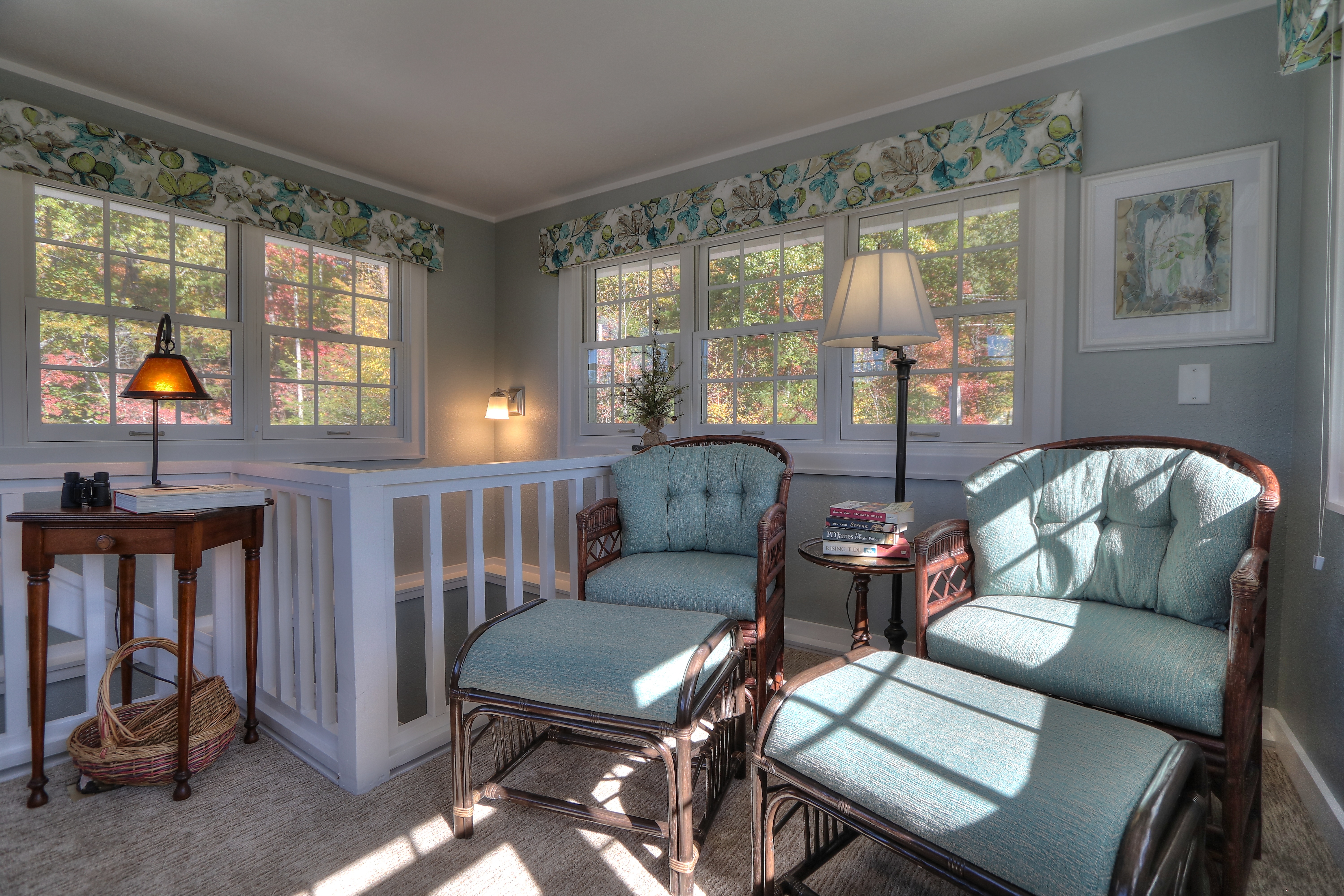 Tower sitting room with wicker furniture and wraparound windows at Buckhorn Inn, Gatlinburg, USA
