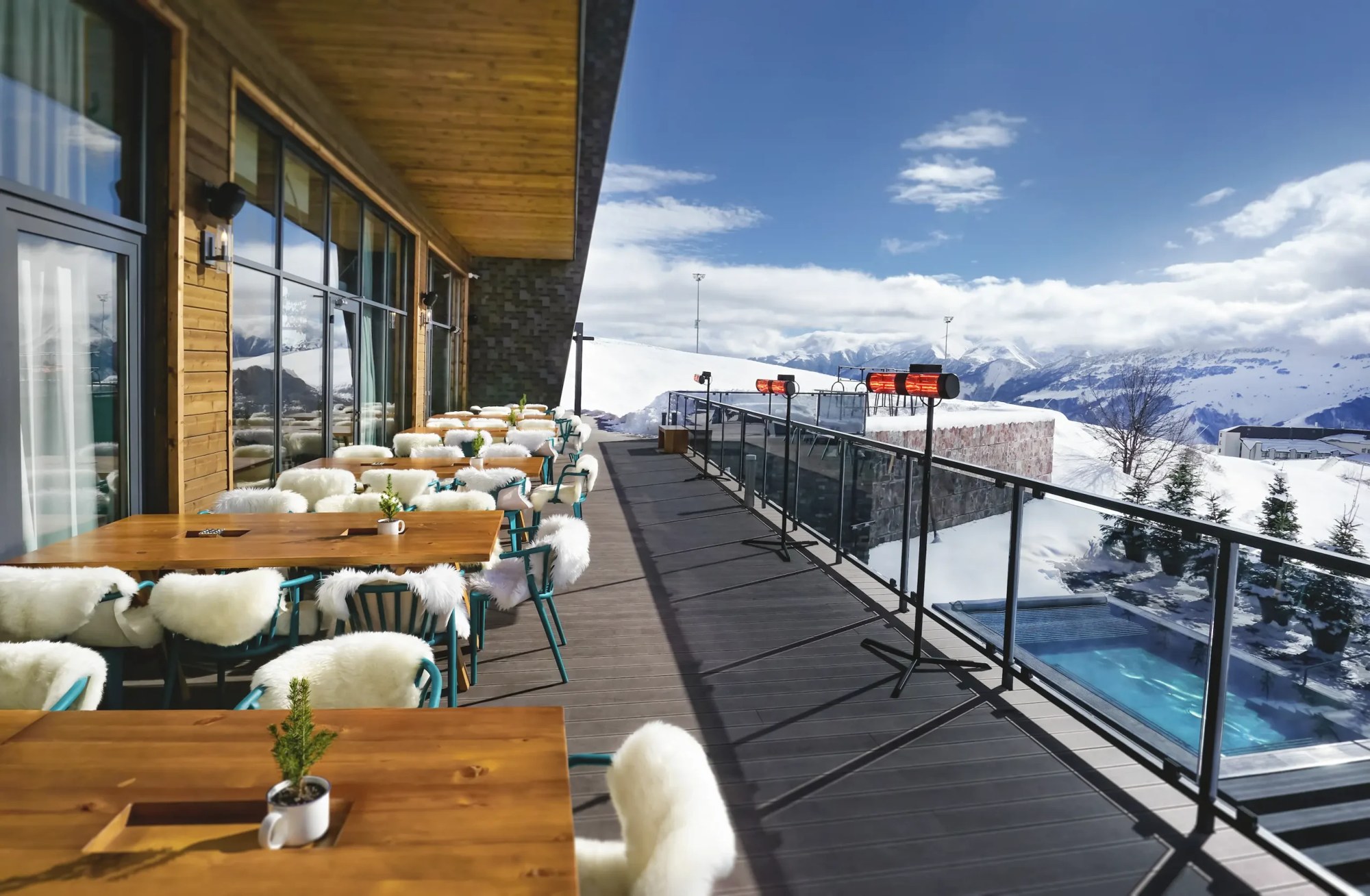 Restaurant terrace overlooking snowy slopes at Gudauri Lodge