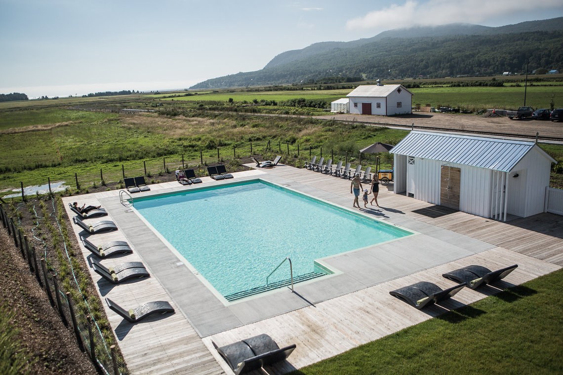Outdoor swimming pool and sun loungers at Le Germain Charlevoix