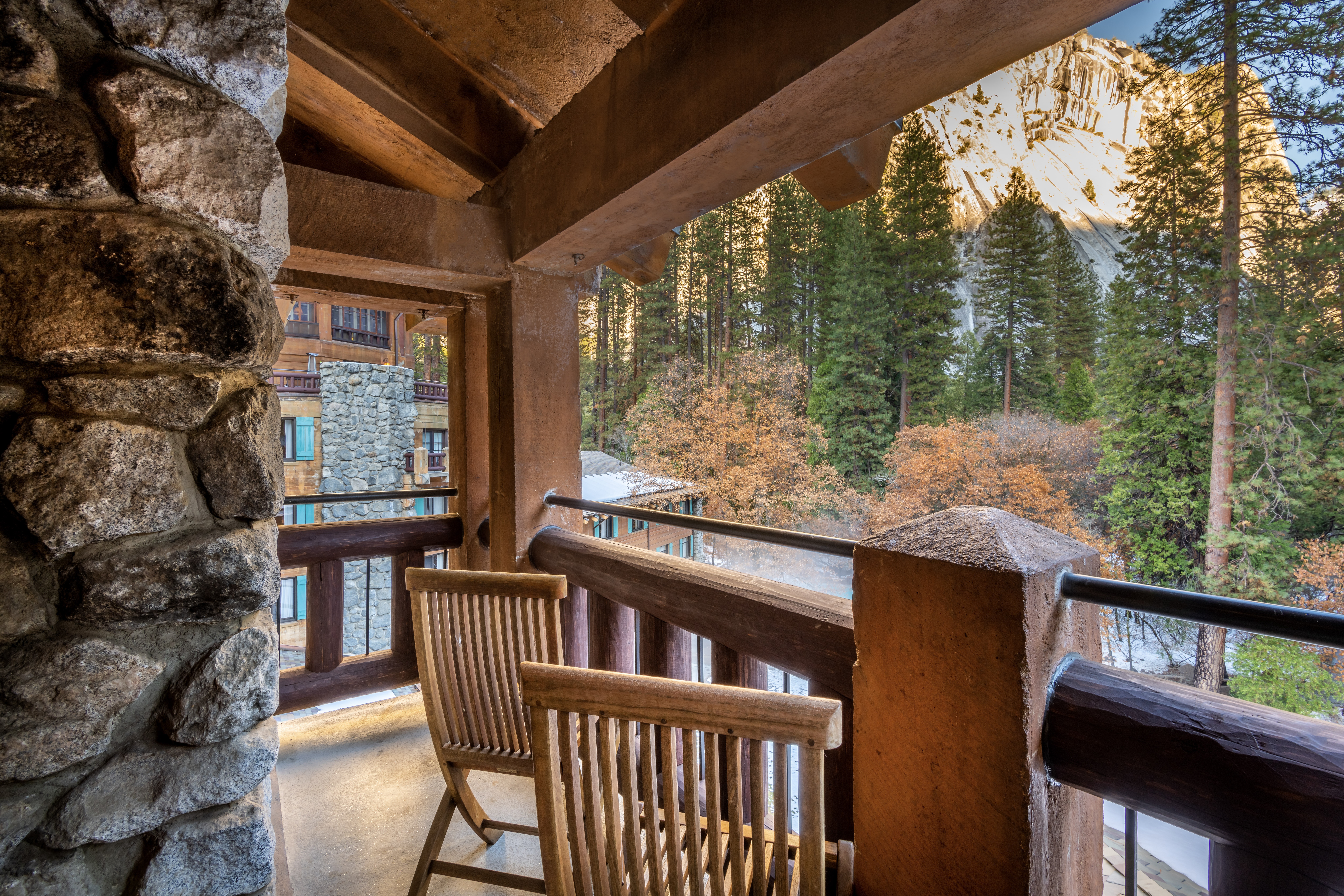 Covered stone balcony with forest views at The Ahwahnee, Yosemite National Park, USA