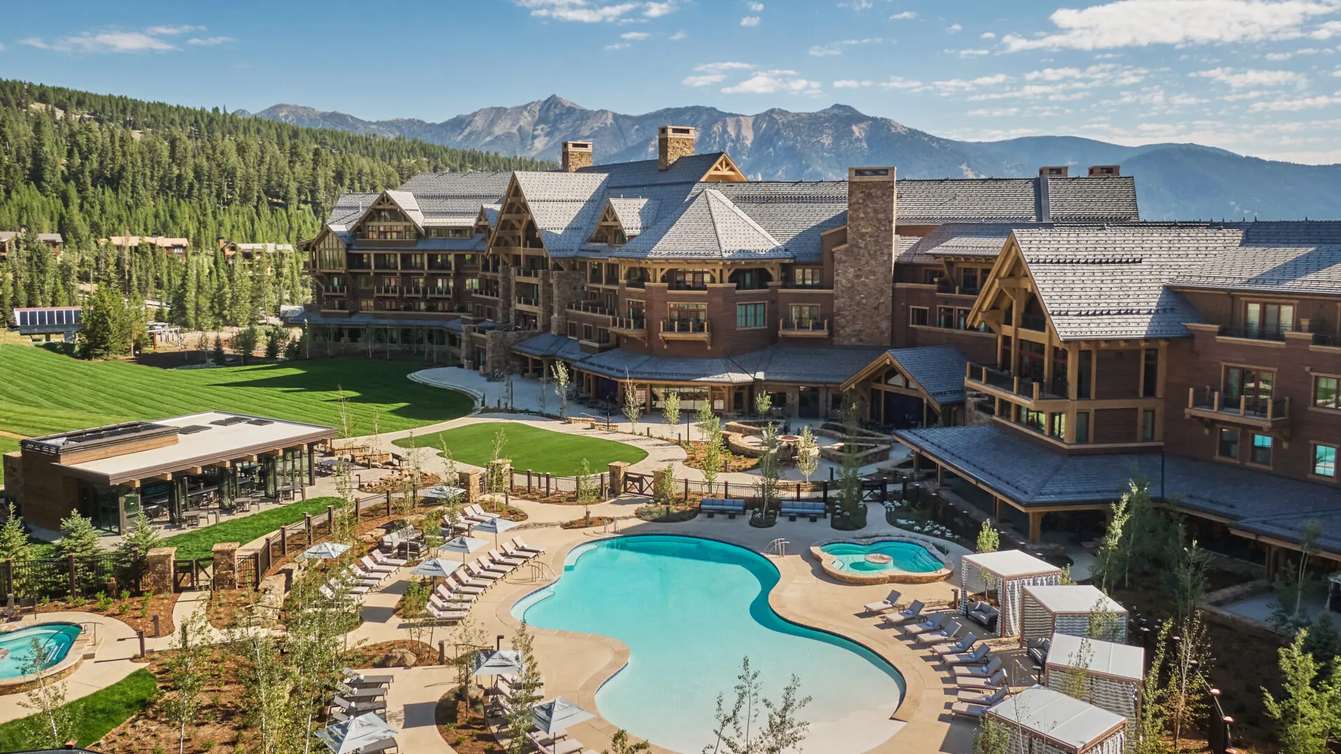 Outdoor swimming pool and resort exterior at Montage Big Sky, Big Sky, USA