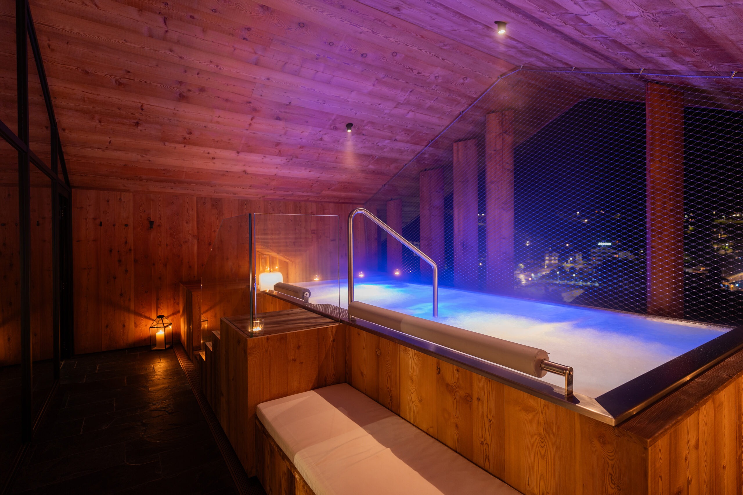 Spa whirlpool and relaxation chairs at night, Hotel de Lën, Cortina d’Ampezzo, Italy
