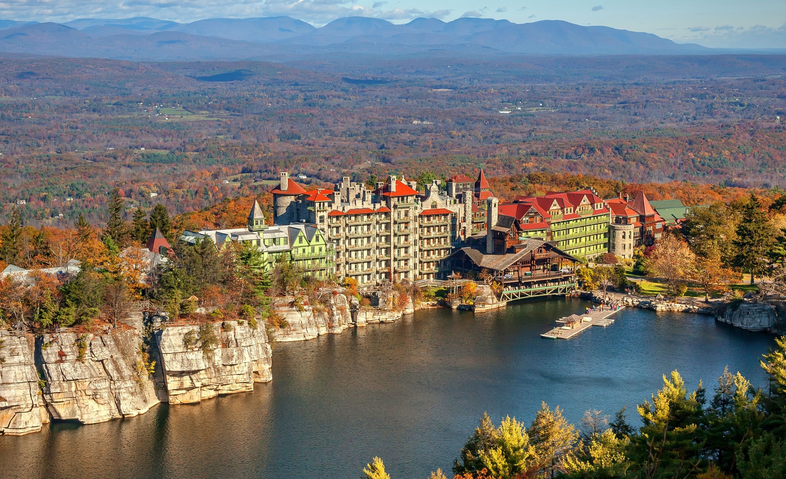 Mountain House overlooking its lake and surrounding autumn woodland at Mohonk Mountain House, New Paltz, USA