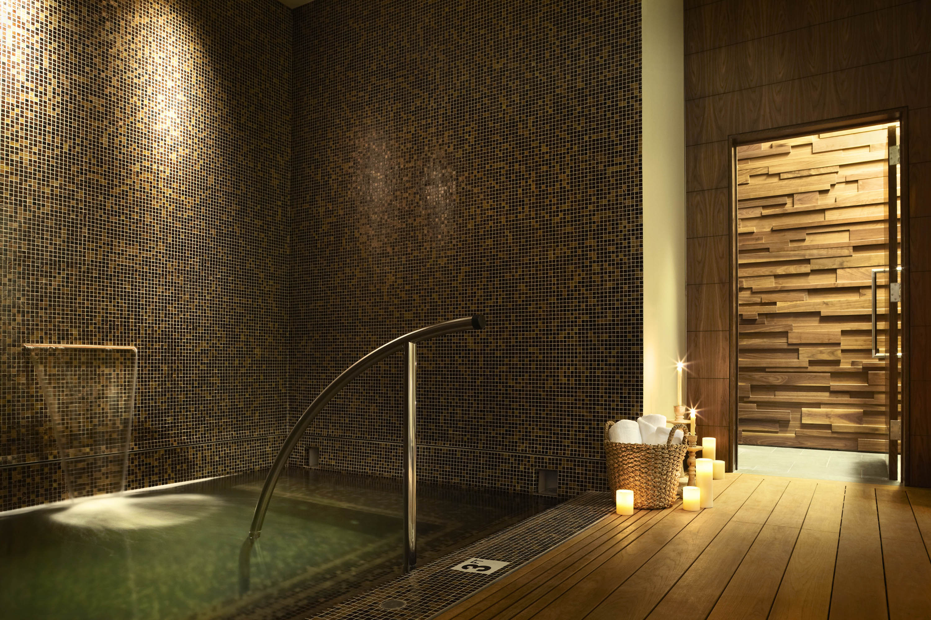 Mosaic-lined wading pool and handrail in the candlelit spa at Viceroy Snowmass.