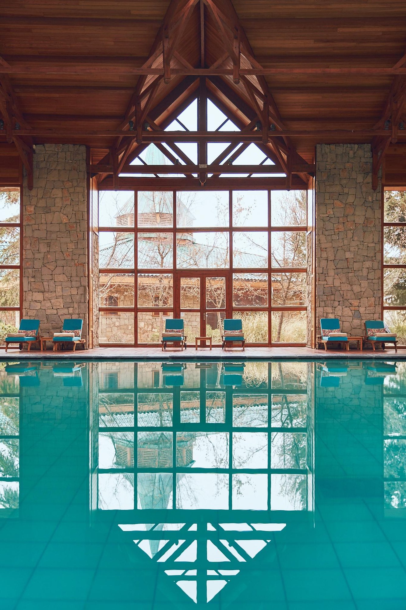 Indoor pool beneath timber beams at Michlifen Resort & Golf