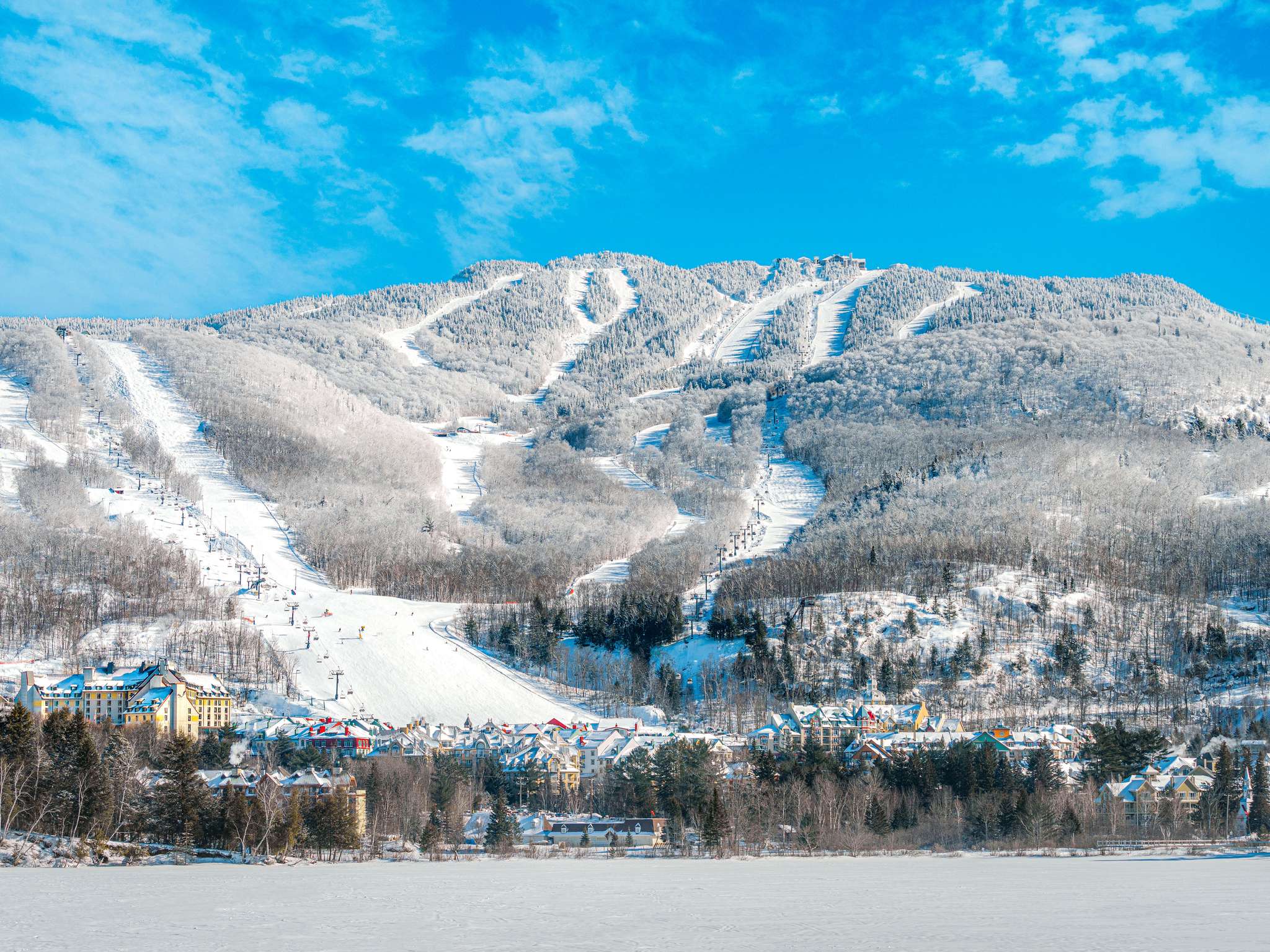 Snow-covered Mont-Tremblant ski slopes and lifts above the resort village, viewed from Fairmont Tremblant