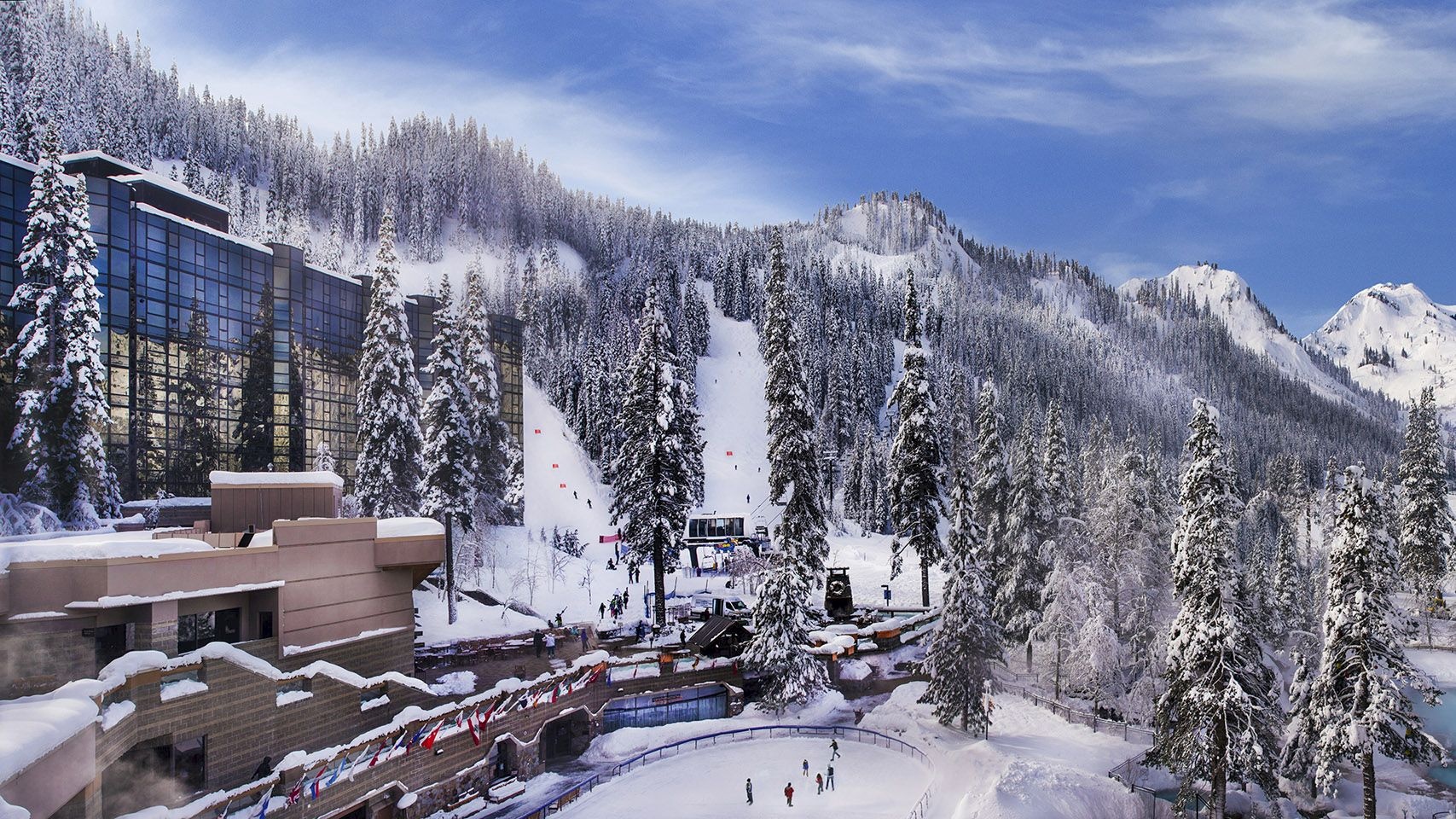 Resort buildings and snowy mountain slopes in Olympic Valley at Everline Resort & Spa, Palisades Tahoe, USA