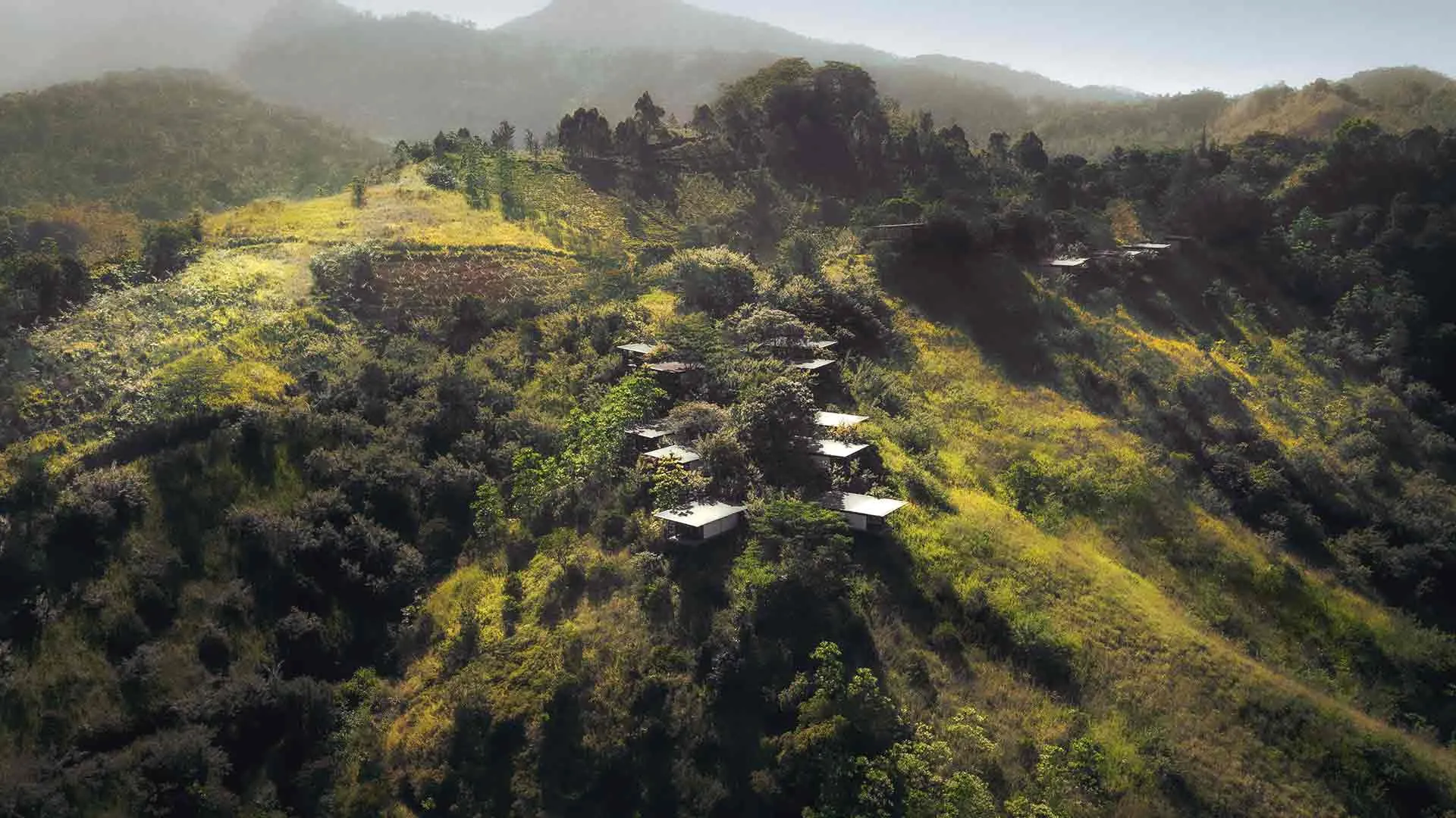 Minimalist chalets scattered across the forested hillside above the valley at Santani Wellness Resort & Spa, Sri Lanka