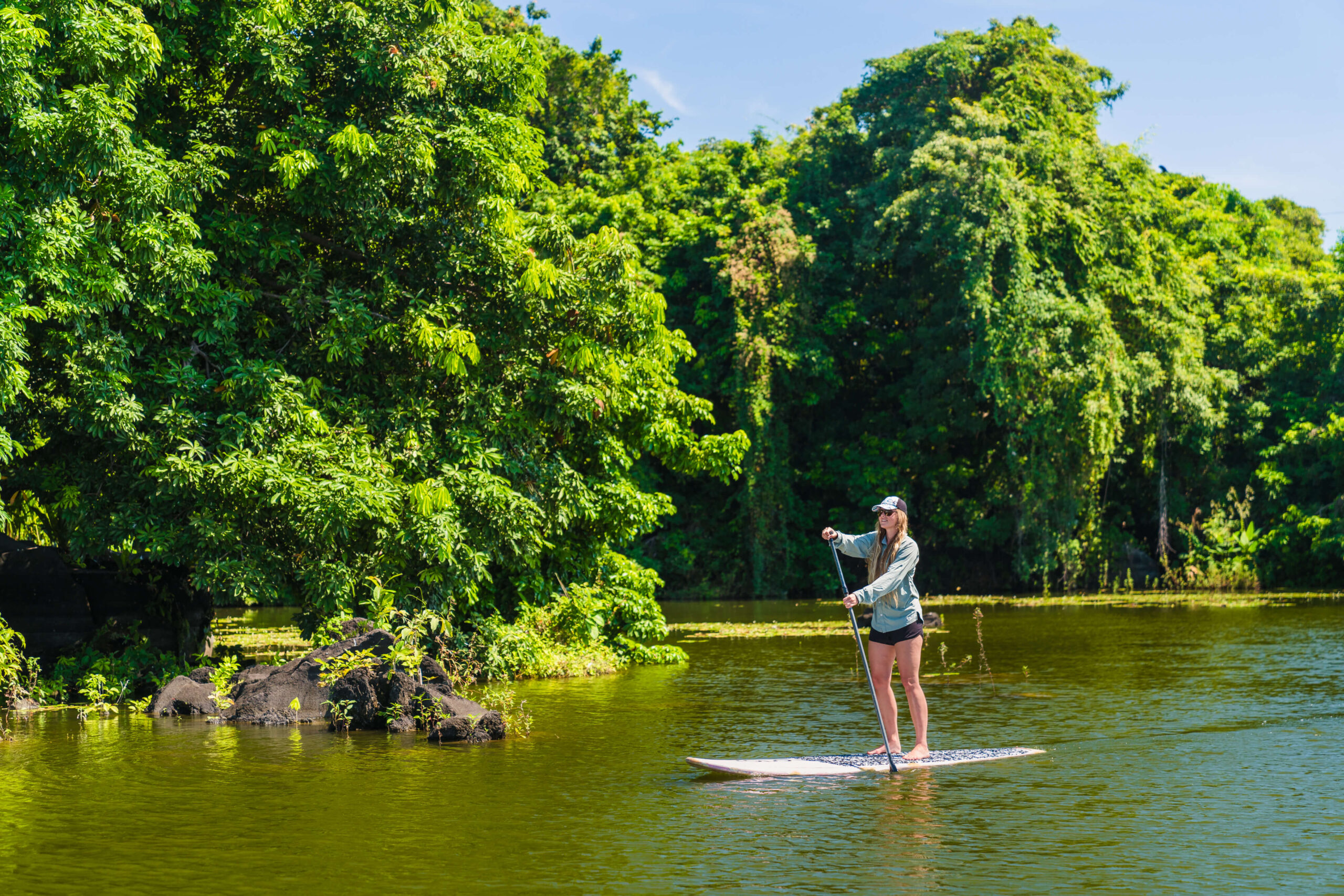 Paddle-boarding beside the forested island, Jicaro Island Ecolodge, Lake Nicaragua, Granada, Nicaragua