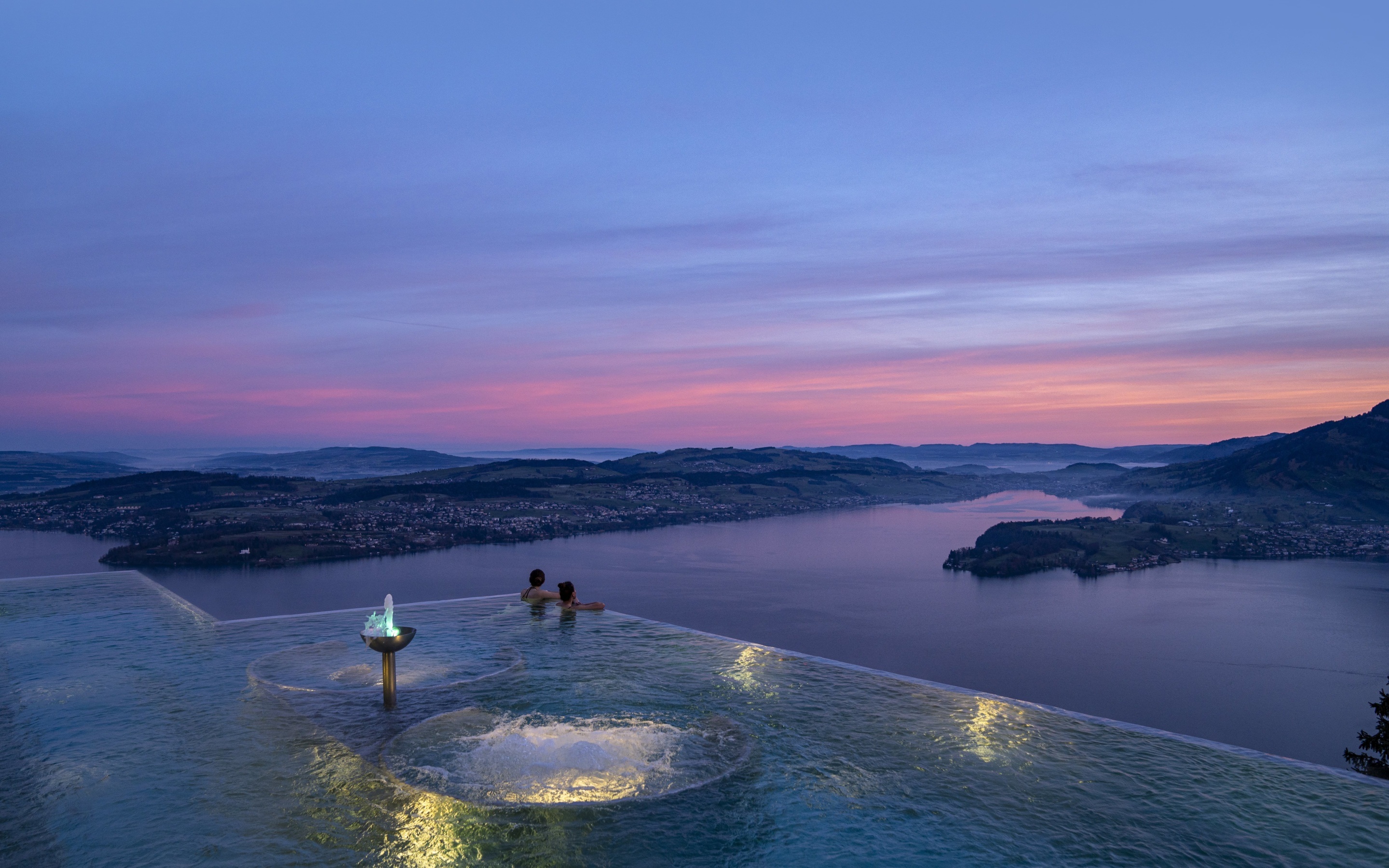 Infinity pool overlooking Lake Lucerne at sunset at Bürgenstock Resort, Lake Lucerne, Switzerland
