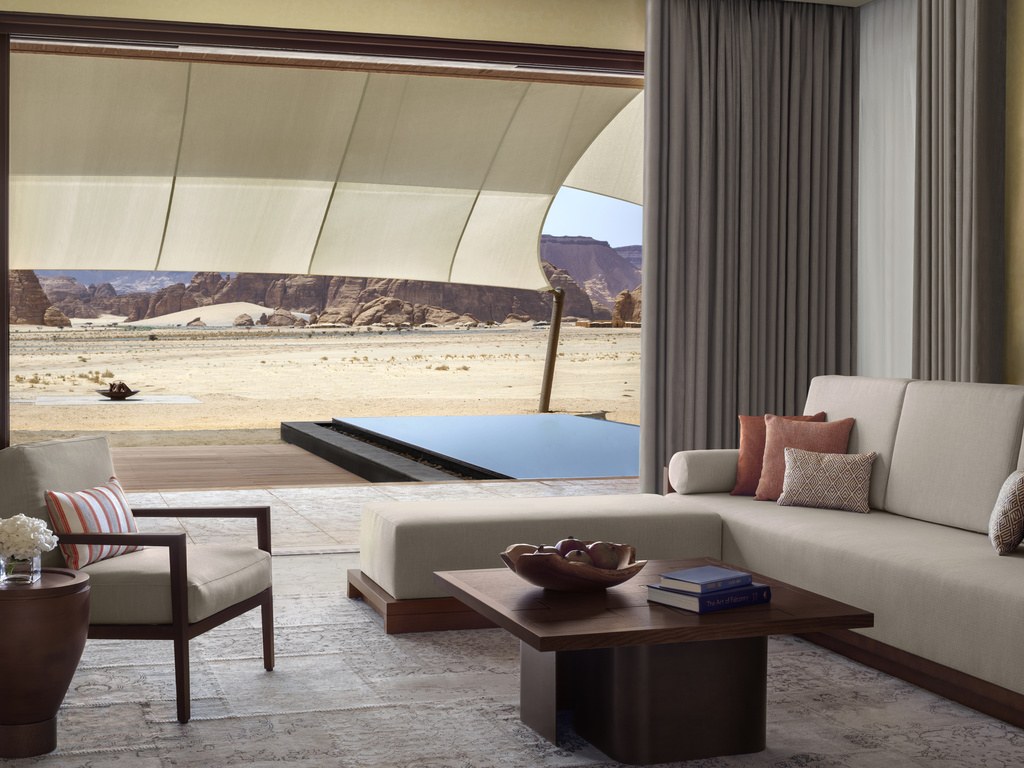 Villa living room opening to a private pool and desert views at Banyan Tree AlUla.