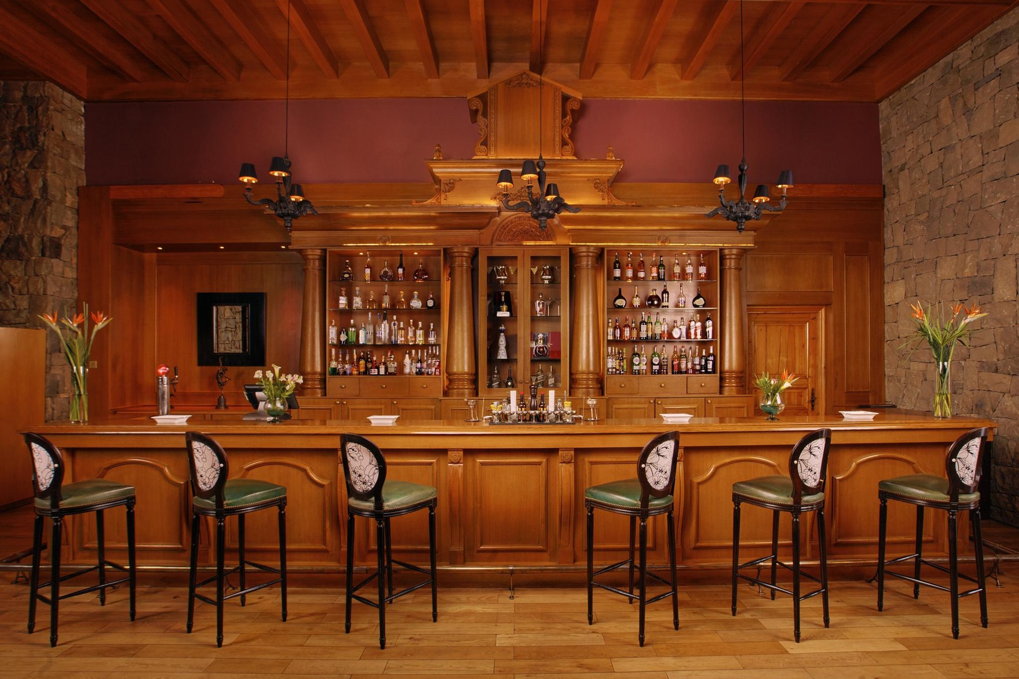 Wood-panelled bar and leather armchairs at Michlifen Resort & Golf