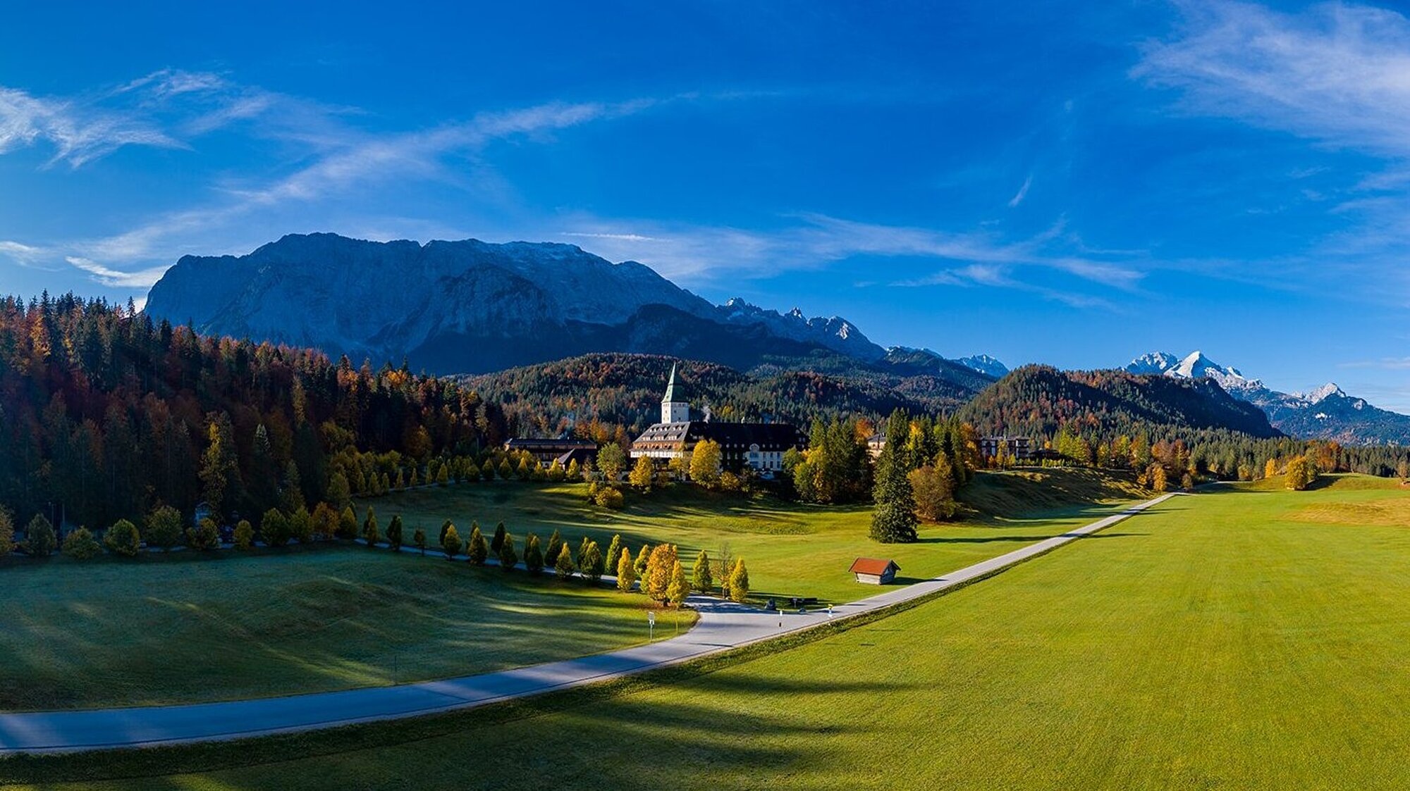 Panorama of Elmau valley with chapel and Wetterstein mountains in autumn, Bavarian Alps, Germany