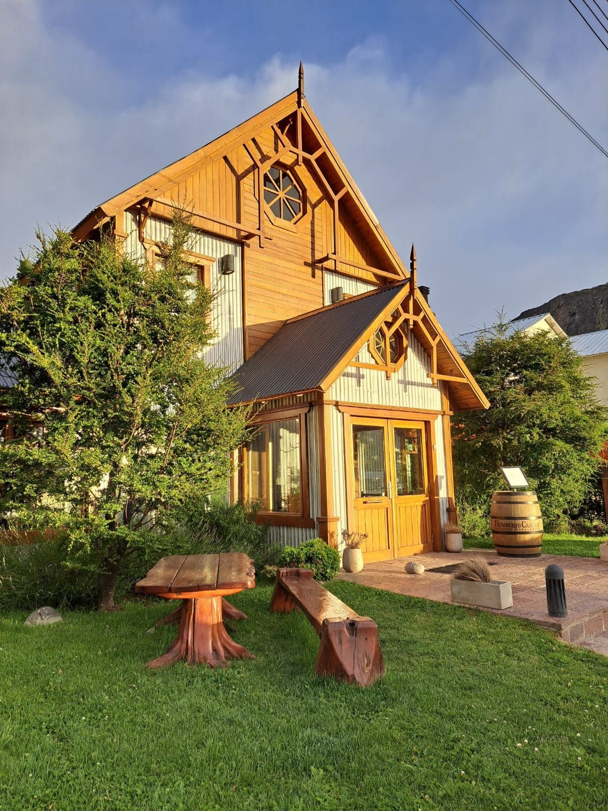 Timber-clad lodge exterior and garden at Hostería Senderos, El Chaltén, Argentina