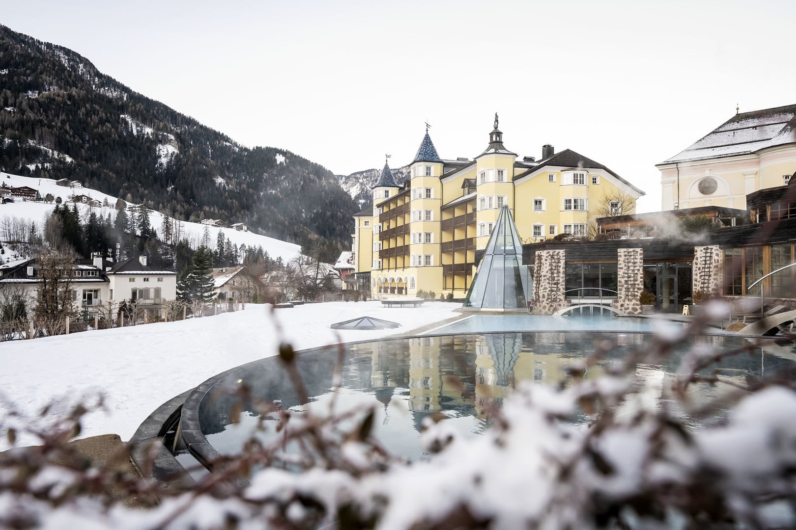 Snowy hotel exterior and outdoor pool in mountain setting, ADLER Spa Resort Dolomiti, Ortisei, Italy