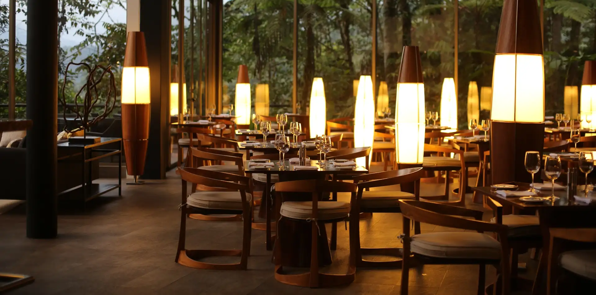 Restaurant tables beside forest-facing windows at Mashpi Lodge, Ecuador