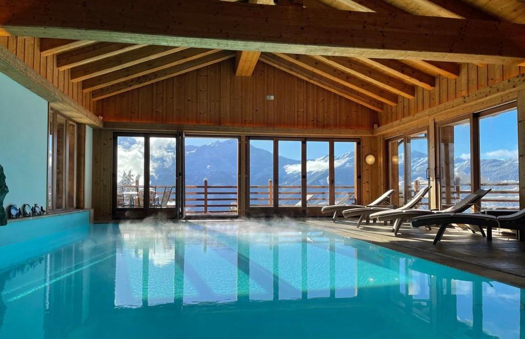 Wide view of the timber-roofed indoor swimming pool, Chalet d'Adrien, Verbier, Switzerland