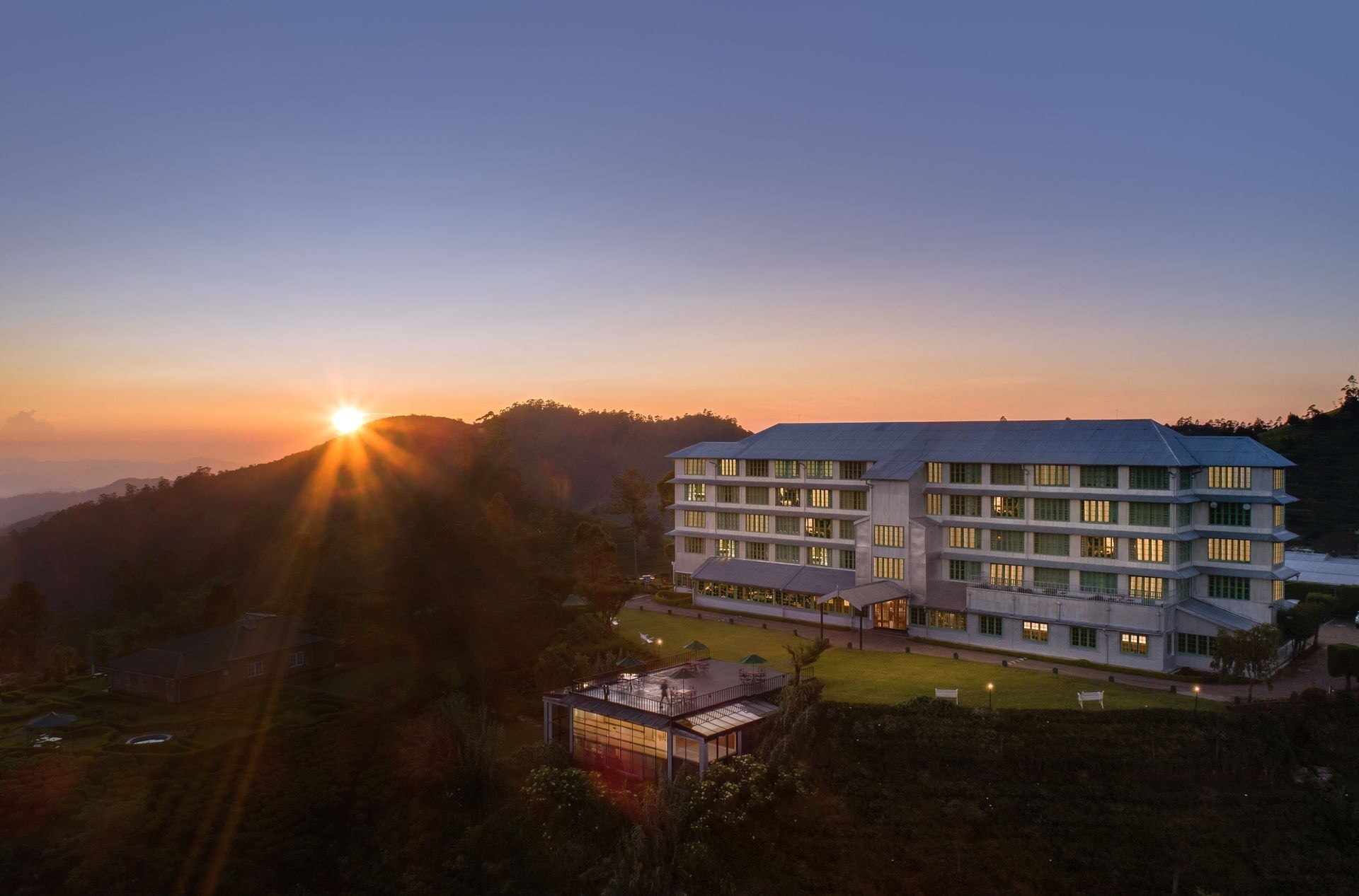 Heritance Tea Factory on a mountain ridge at sunrise
